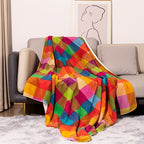 Colorful checkered blanket draped over a gray sofa in a living room.