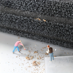 Two small figures standing on a textured surface with a close-up of the material above them.
