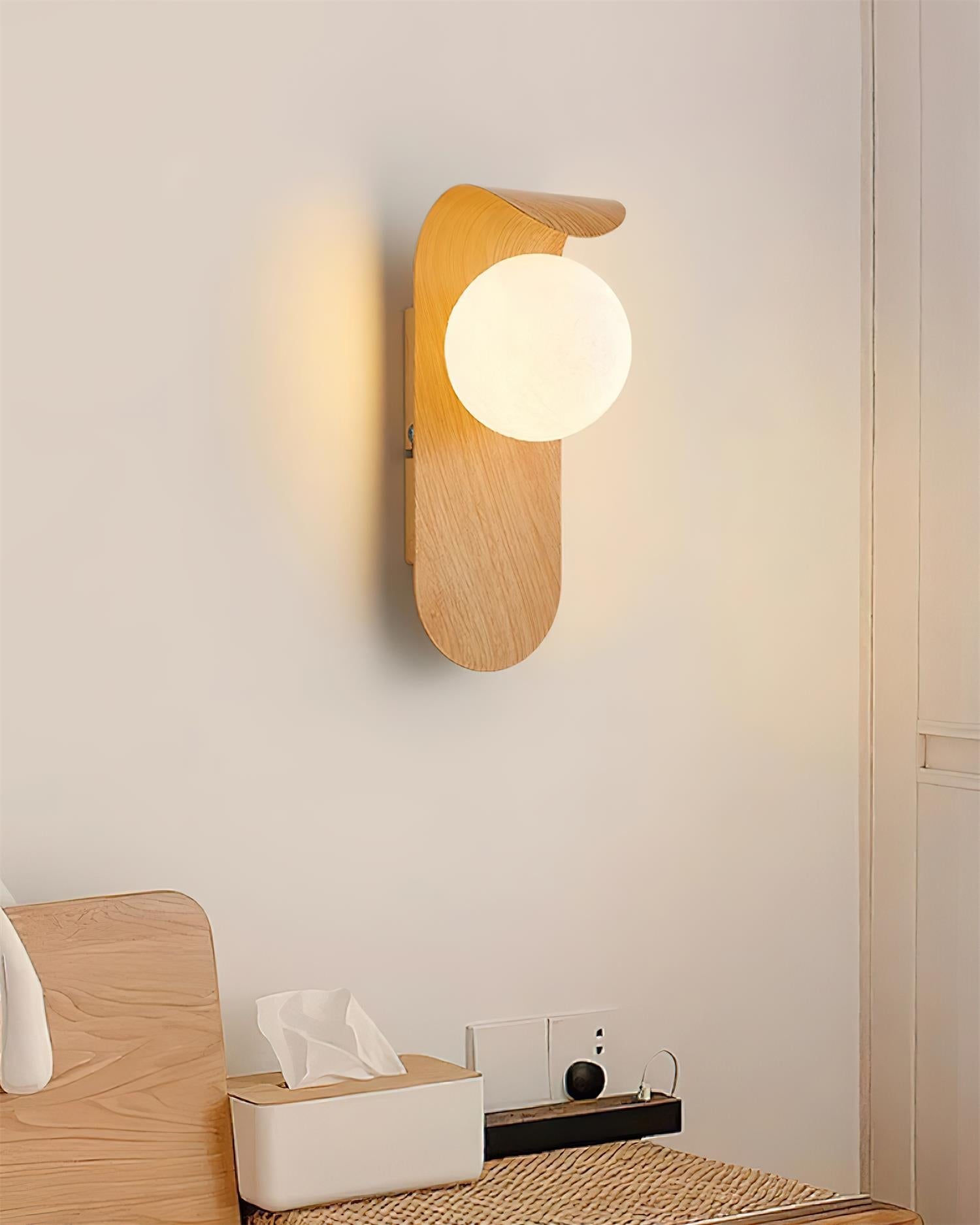 Wooden wall lamp on a light gray wall with a minimalistic setup.
