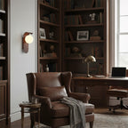 Cozy home office with leather armchair, bookshelves, and desk.