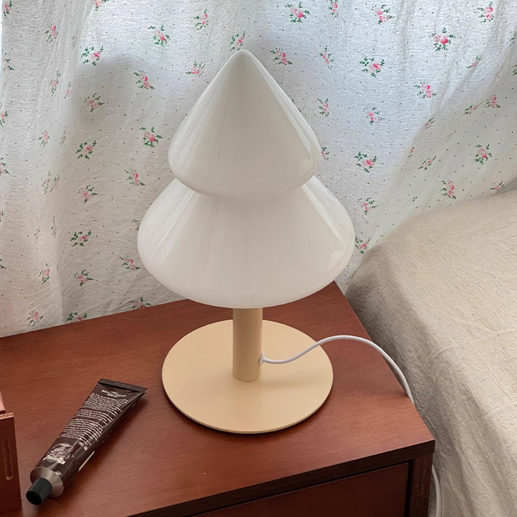 White table lamp on a wooden surface with floral wallpaper in the background