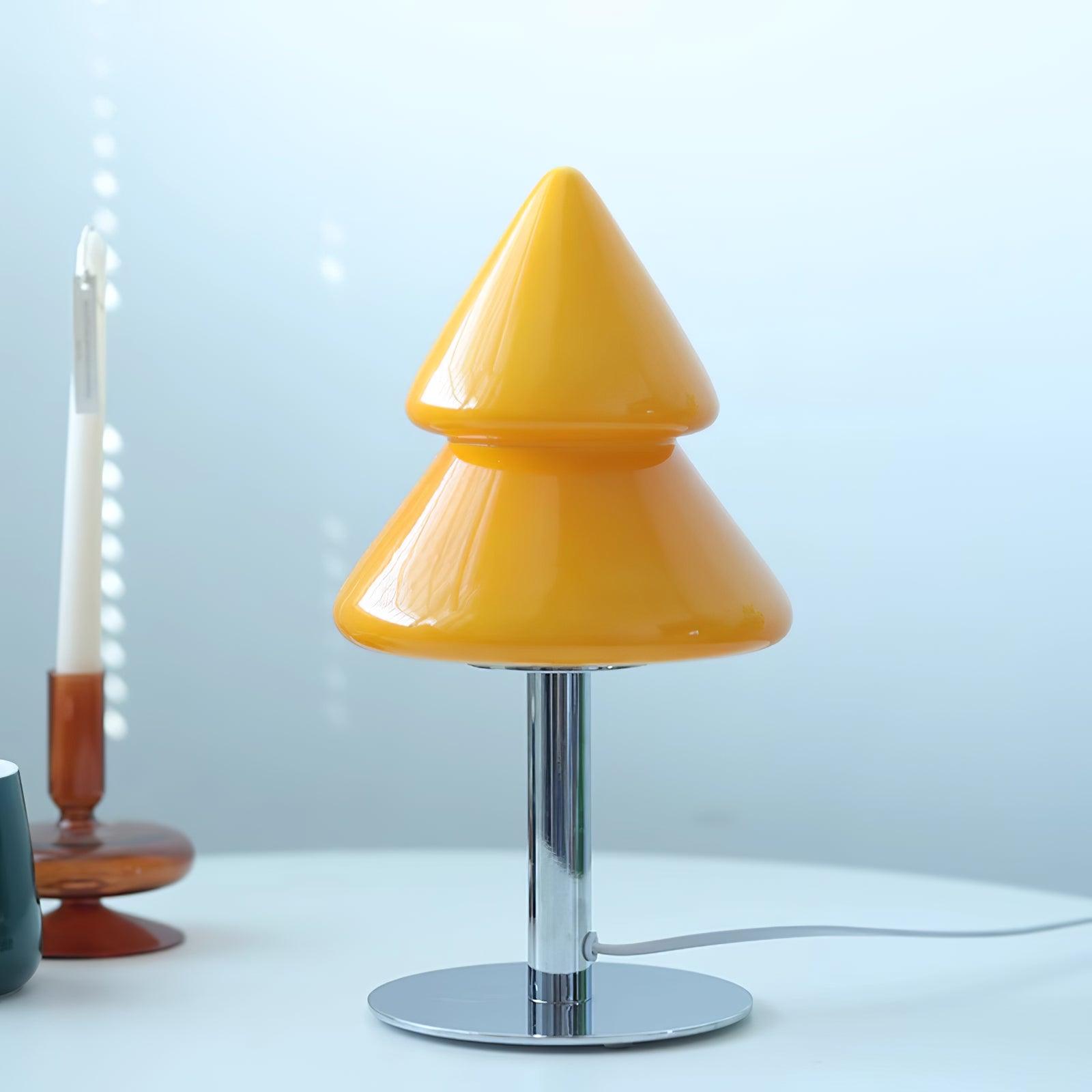 Yellow cone-shaped table lamp on a white surface with a light blue background