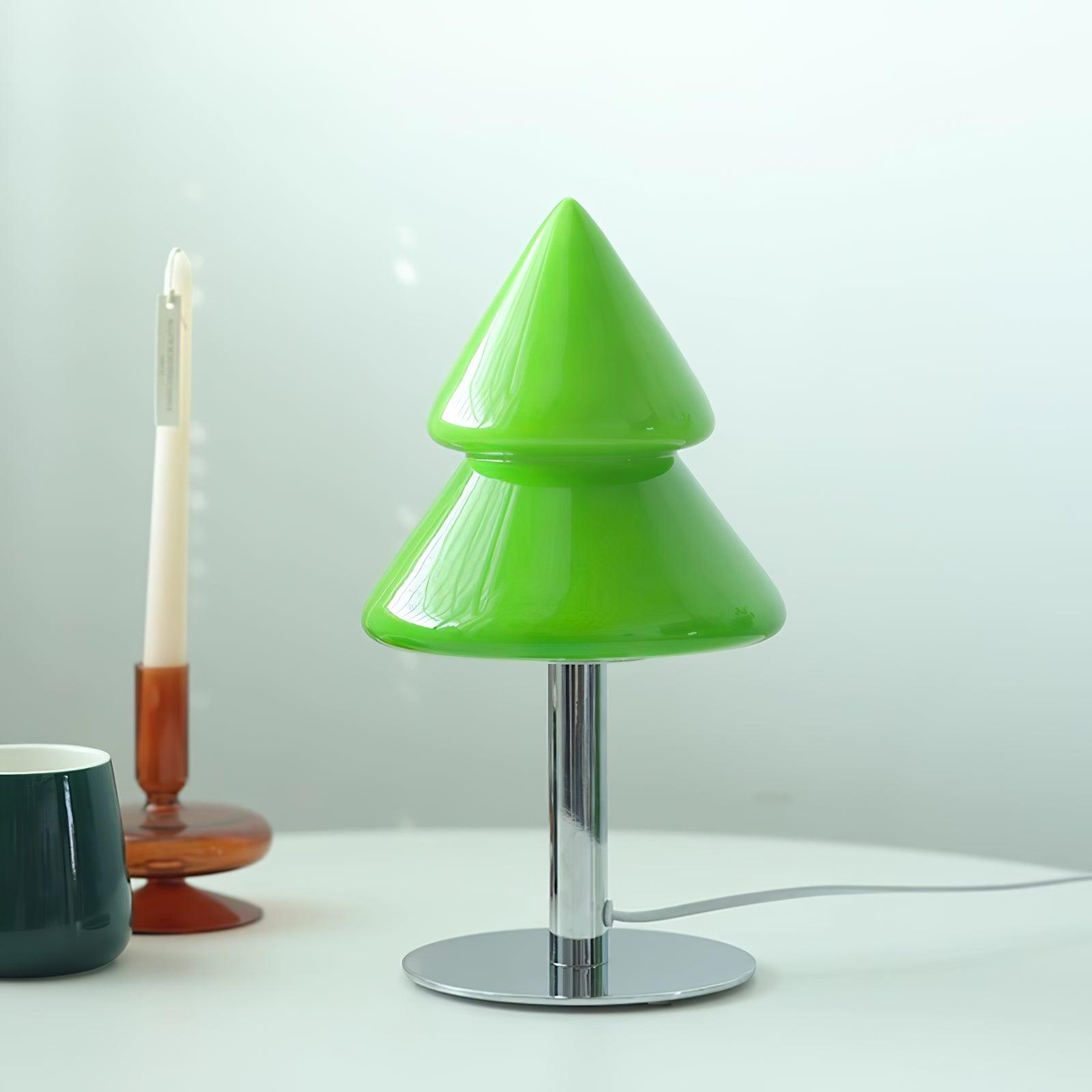 Green cone-shaped table lamp on a white surface with a neutral background