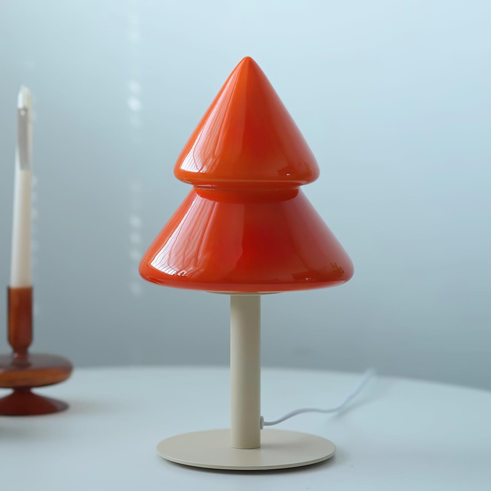 Red cone-shaped table lamp on a white surface with a light blue background