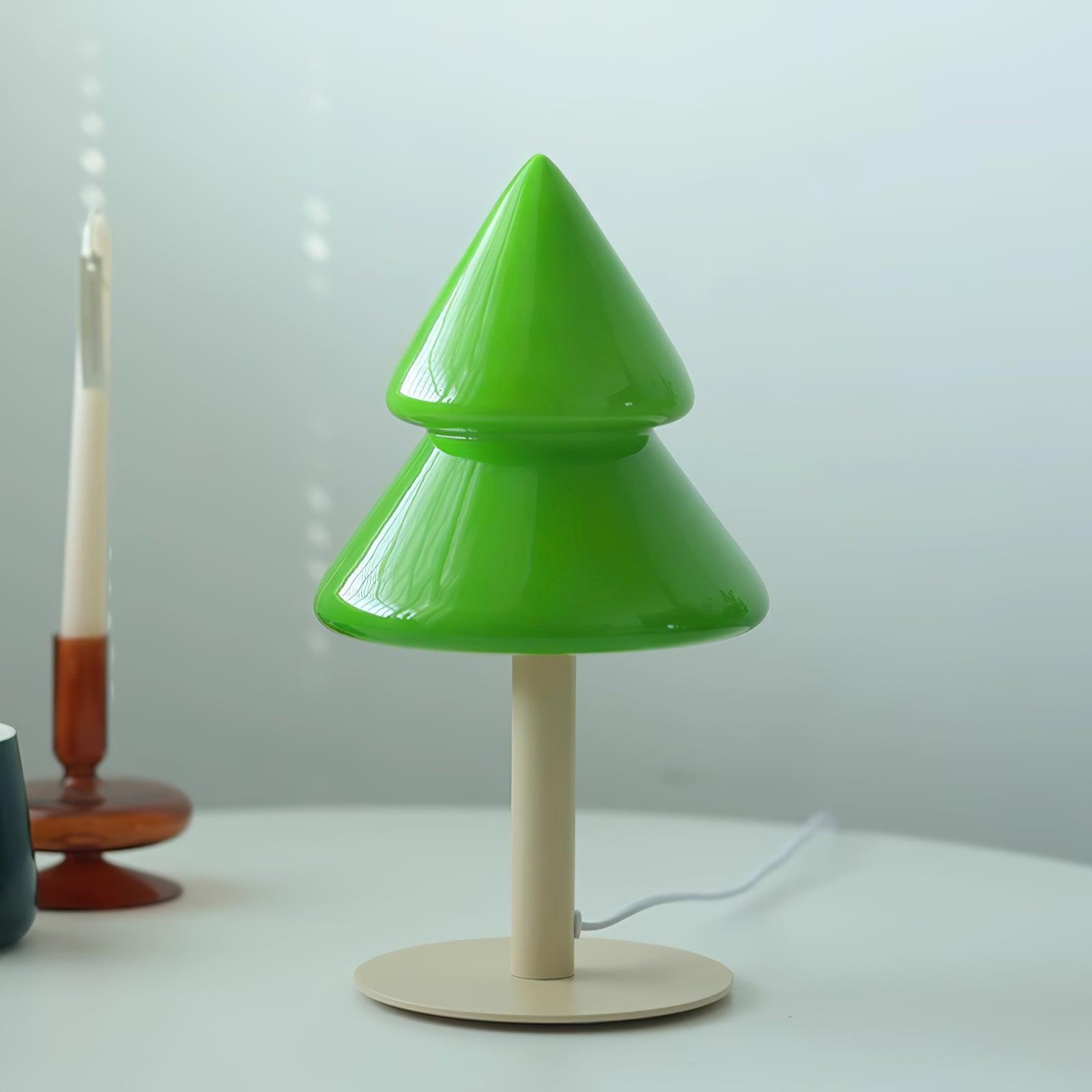 Green cone-shaped lamp on a white surface with a blurred background