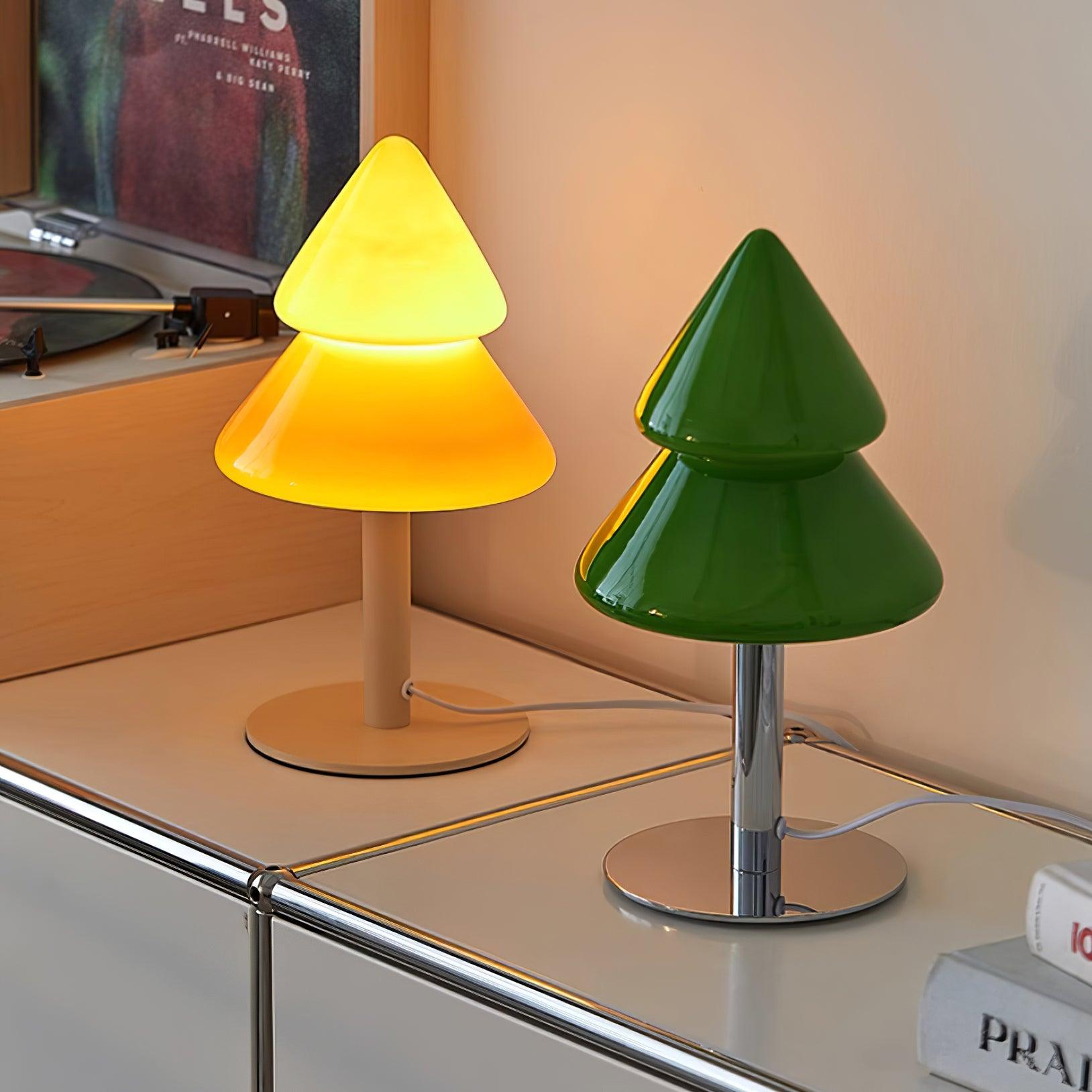 Two cone-shaped table lamps, one yellow and one green, on a surface.