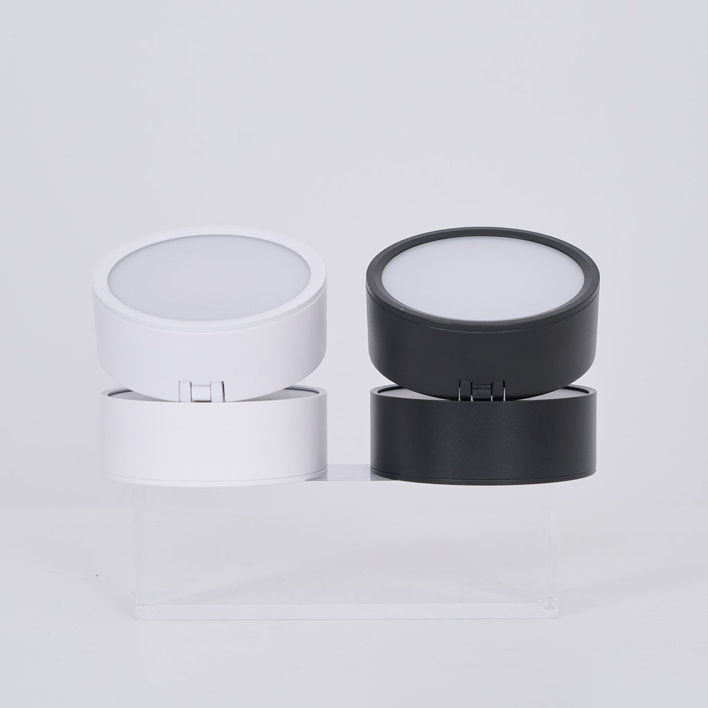 Two cylindrical containers, one white and one black, on a light gray background.
