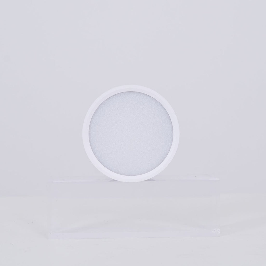 White circular lamp on a light gray background
