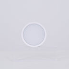 White circular lamp on a light gray background