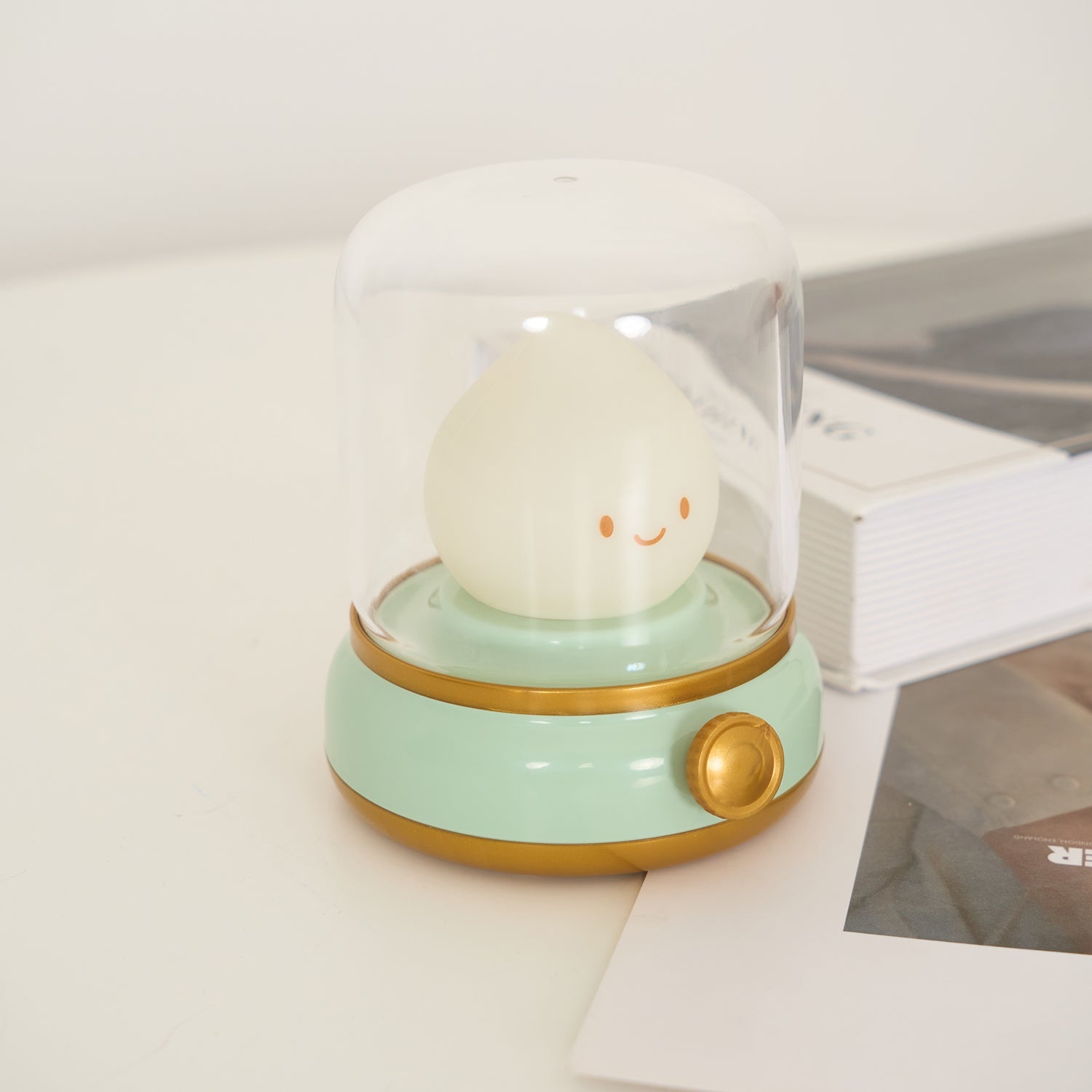 Small round lamp with a smiling face on a light green base