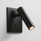 Black wall-mounted light fixture on a gray background