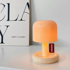 Small orange lamp with a tag on a white surface next to a book titled 'Keep It Classy'.