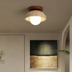 Ceiling light fixture in a room with a painting on the wall