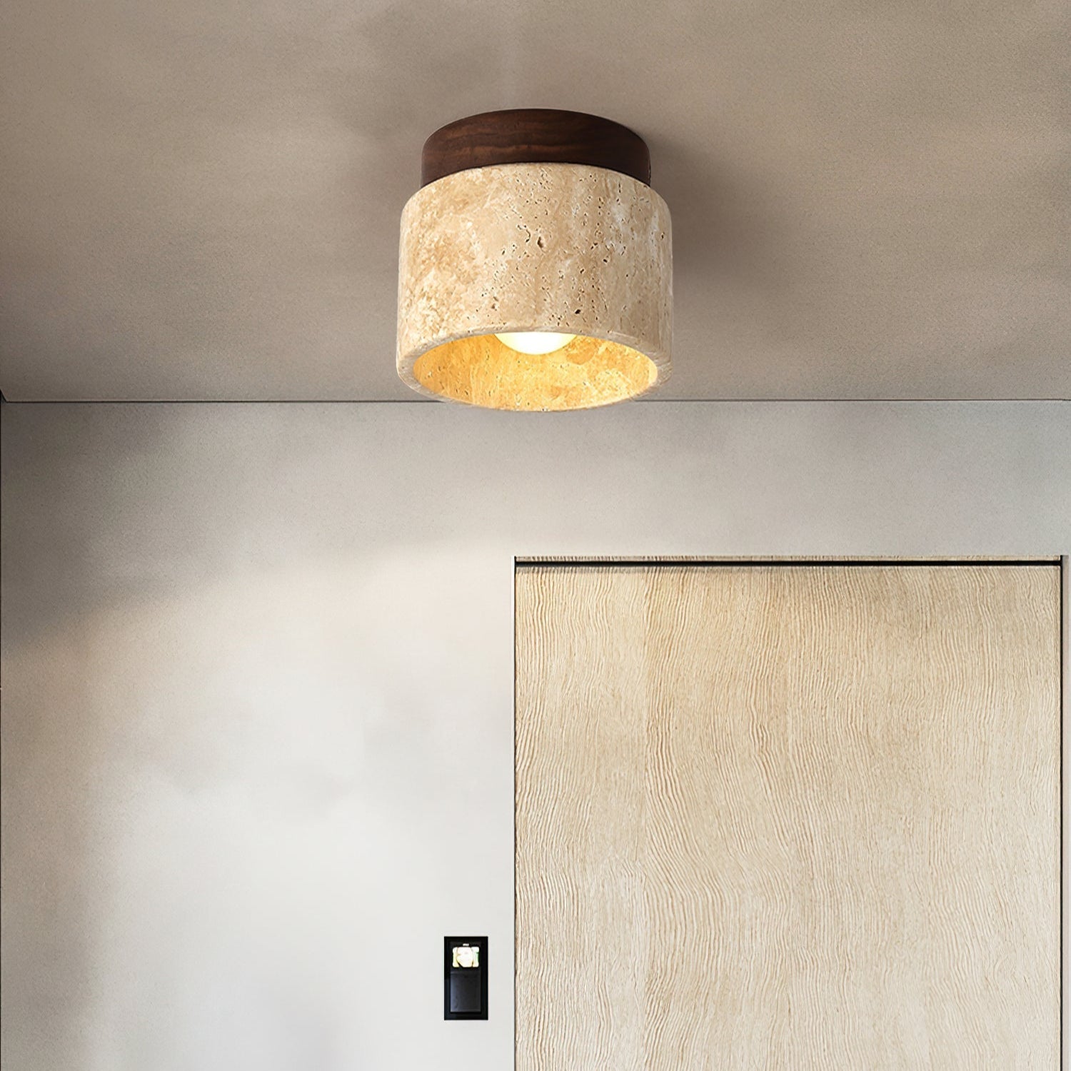 Ceiling light fixture in a modern interior setting with a neutral color palette.