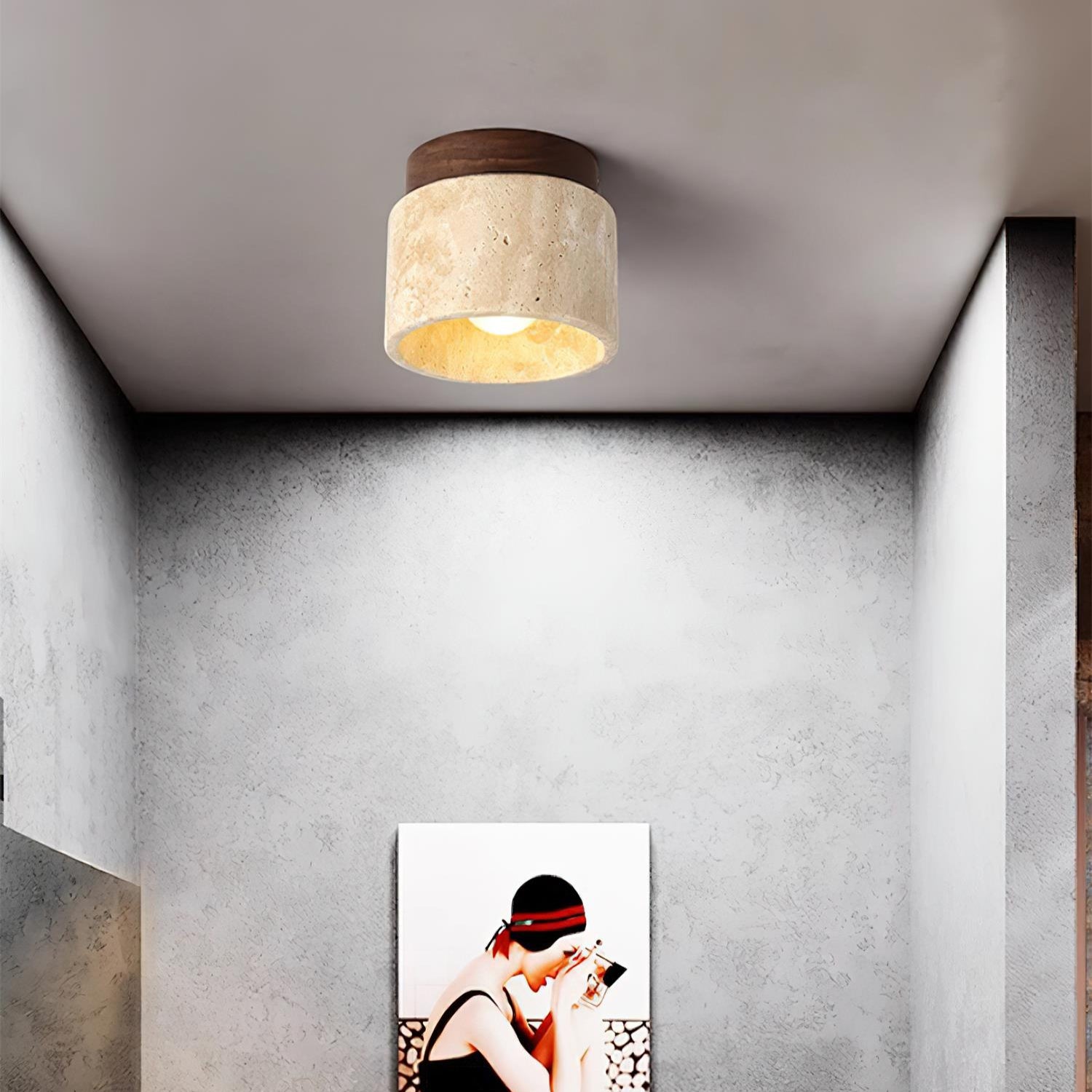 Ceiling light fixture above a wall art piece in a room with gray walls.