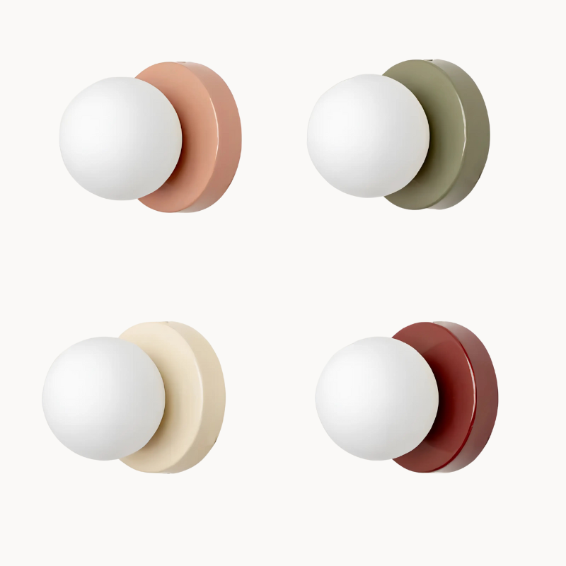 Four wall sconces with different colored bases on a beige background