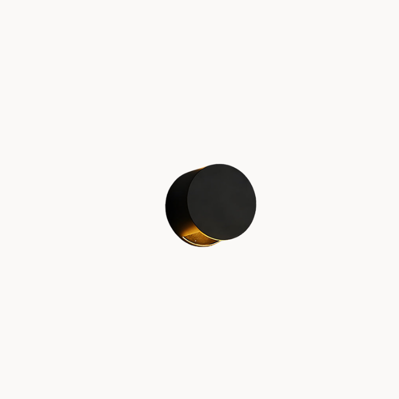 Modern black wall light fixture casting a shadow on a beige background