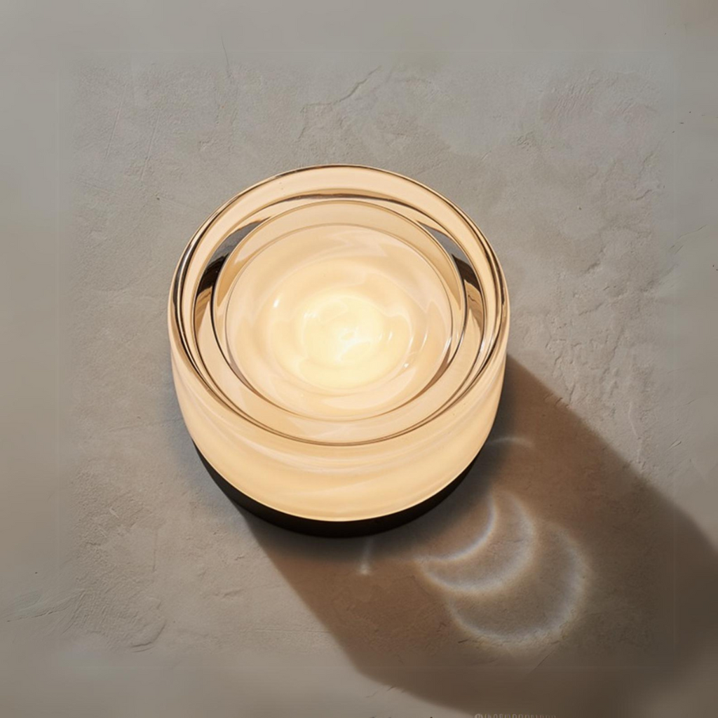 Round wall light fixture on a textured wall in the foreground