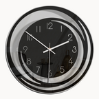 Wall clock with black face and silver frame on a beige background