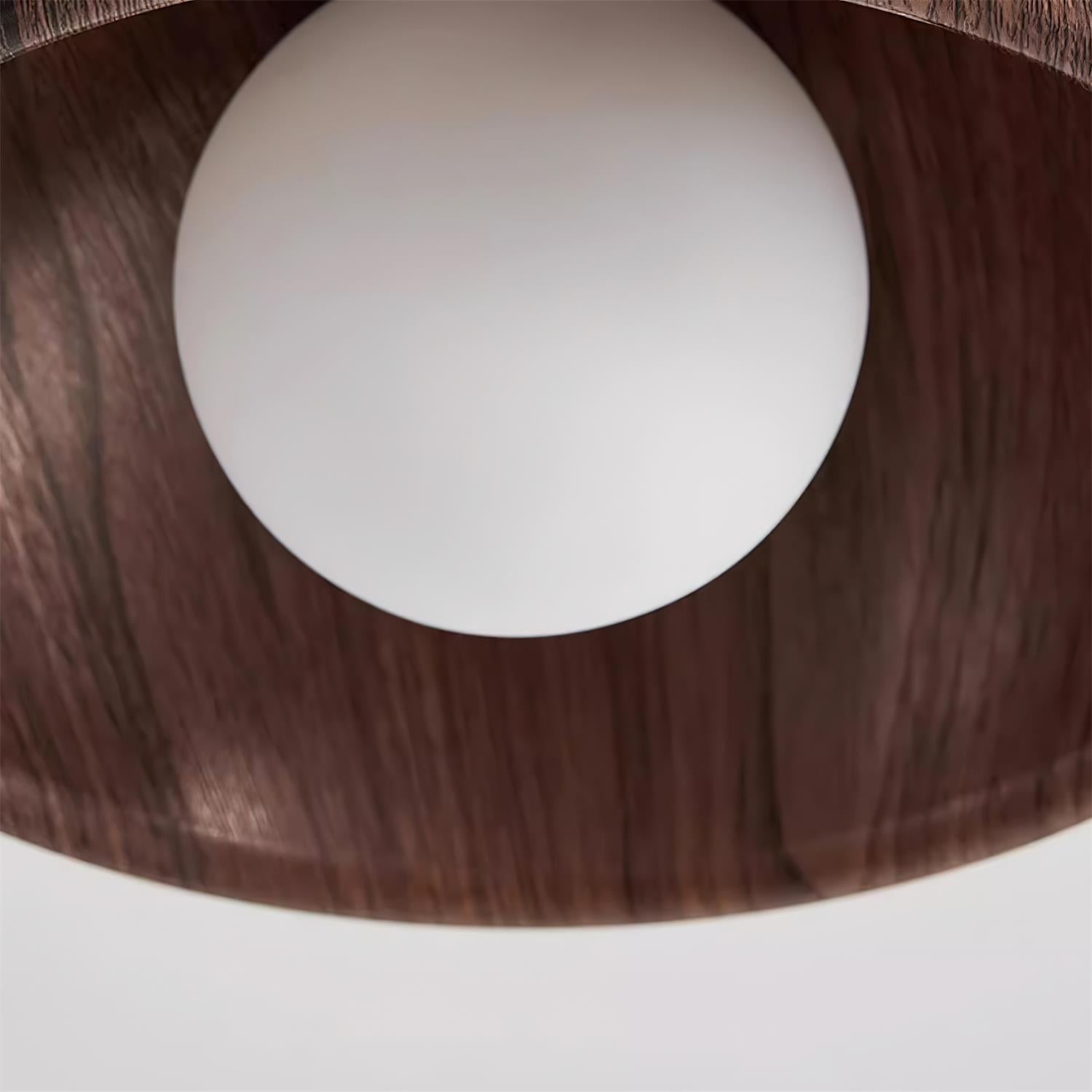Close-up of a wooden lampshade with a white bulb inside