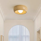 Ceiling light fixture in a room with a mirror and decorative elements.