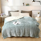 Bed with light blue comforter and pillows in a bedroom setting