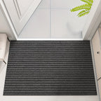 Gray doormat with striped pattern on a white floor