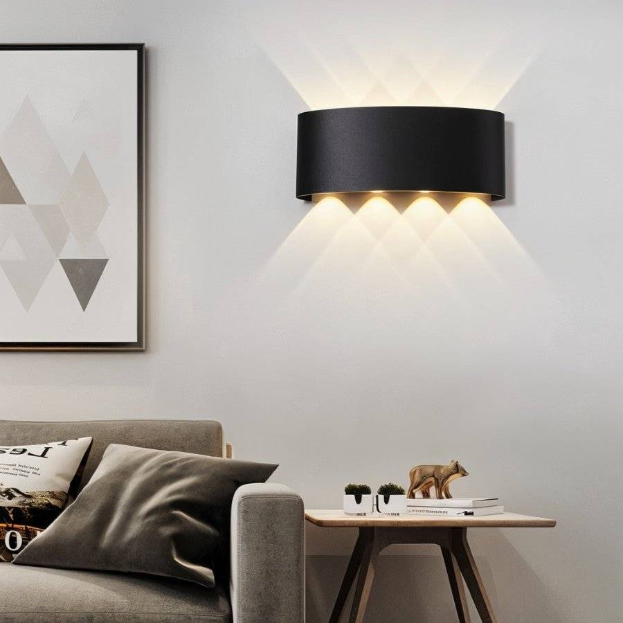Modern living room with a black wall lamp, sofa, and side table.
