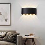 Modern living room with a black wall lamp, sofa, and side table.