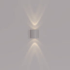 Modern wall-mounted light fixture on a plain wall