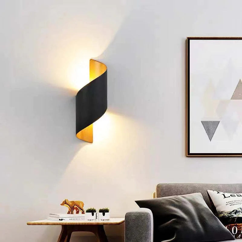 Modern living room with a black wall lamp, sofa, and decorative items.