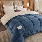 Blue comforter with beige border on a bed in a bedroom setting