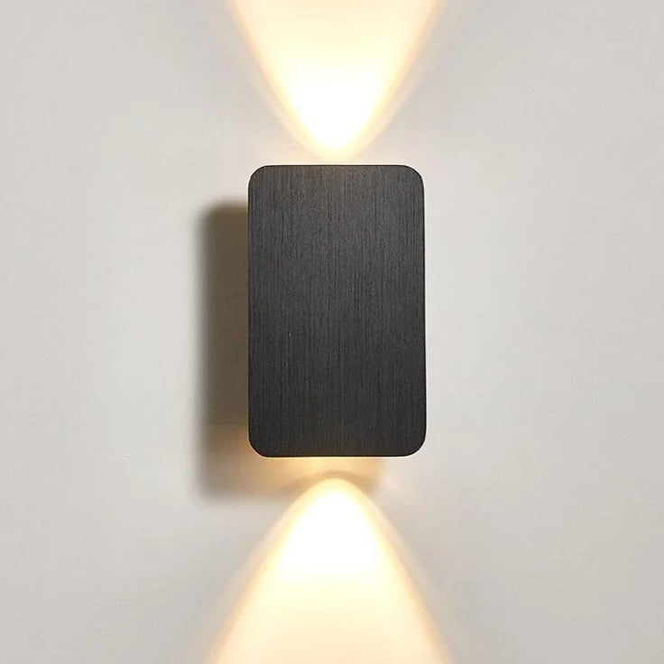 Modern wall-mounted light fixture on a plain wall