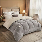 Gray comforter on a bed in a bedroom setting with pillows and decor.