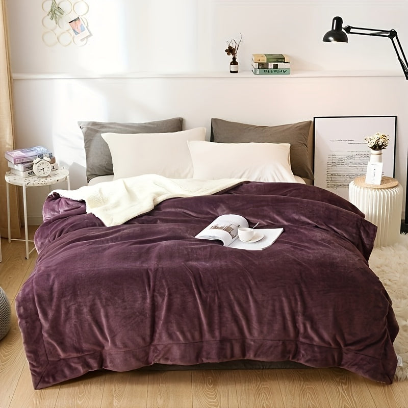 Bedroom with a bed covered in a purple comforter, white pillows, and a wooden nightstand.