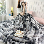 Person holding a gray and white checkered blanket in a cozy room.