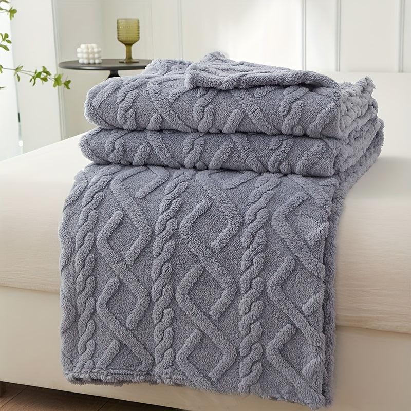 Stack of textured gray towels on a white surface with a blurred background