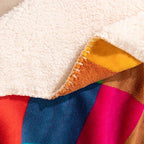 Close-up of a colorful fabric with a white textured surface underneath