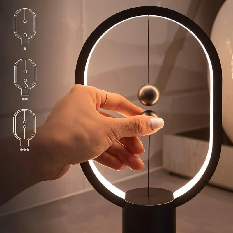 Hand interacting with a modern balance ball device in a softly lit room.