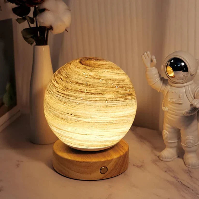 Decorative lamp on a table with an astronaut figurine and a vase in the background