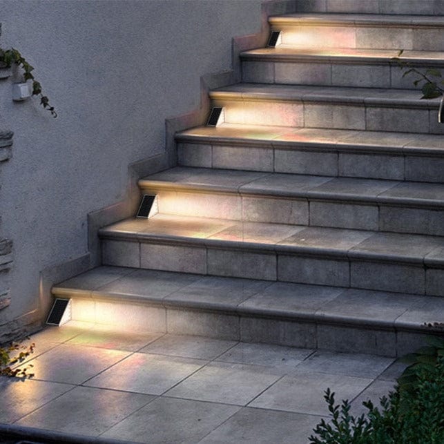 Staircase with embedded lighting fixtures on a concrete wall.