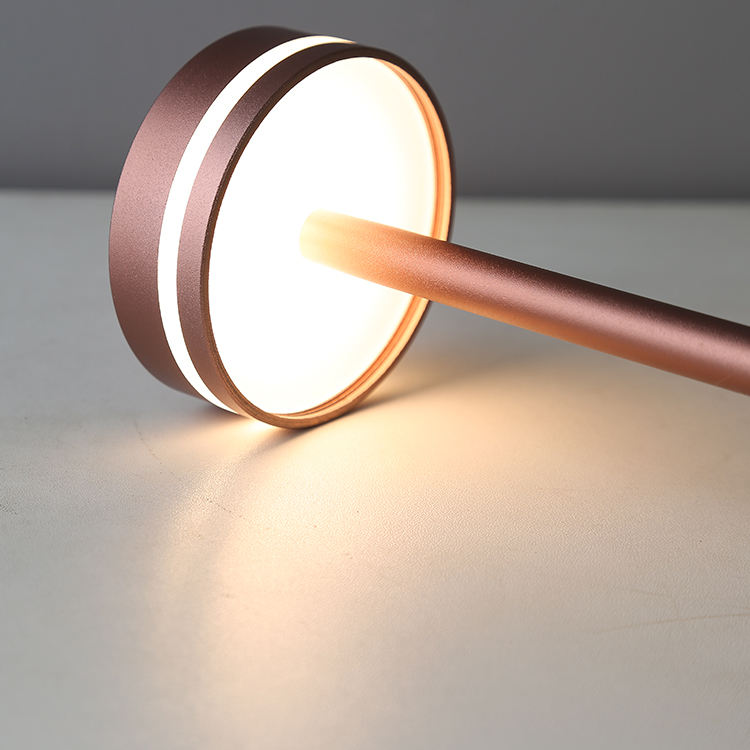Modern table lamp with a copper finish on a neutral background