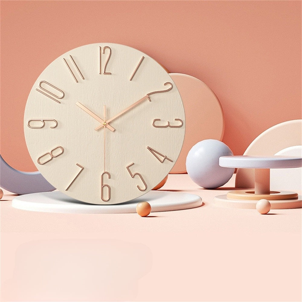 Wooden clock with rose gold hands on a pastel pink background