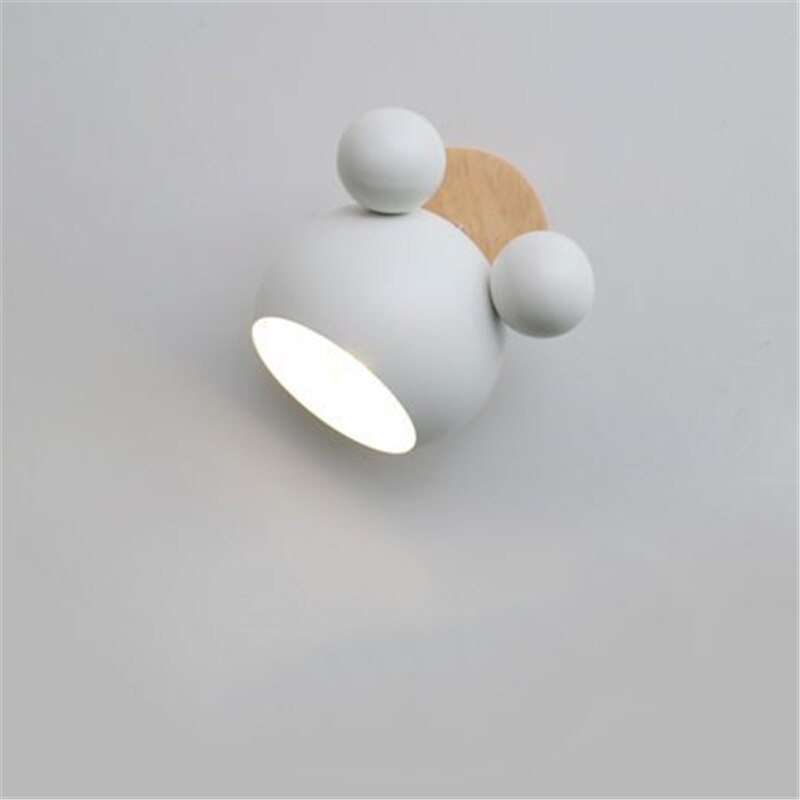 Modern wall light fixture with white and wooden design on a gray background