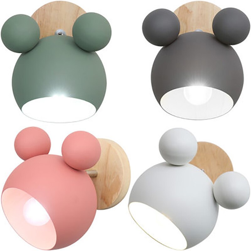 Four wall lights with Kleurful, round designs on a white background